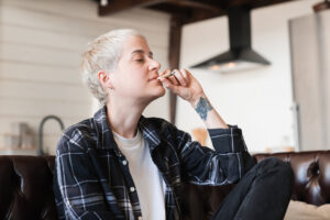 Hipster girl smoking cigarette joint